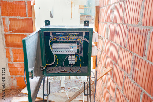 Fuse box, control panel with many various wires and fuses, electrical control panel enclosure for power and distribution electricity on the building site. photo