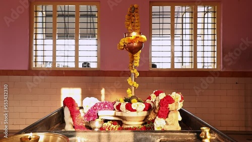 Closeup of shivling with water fountain and decorations photo