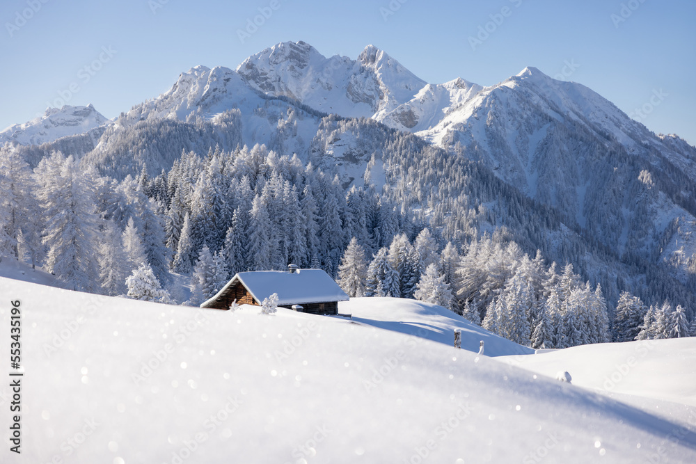 Wooden cabin or hut in the mountains in winter in the Austrian Alps.