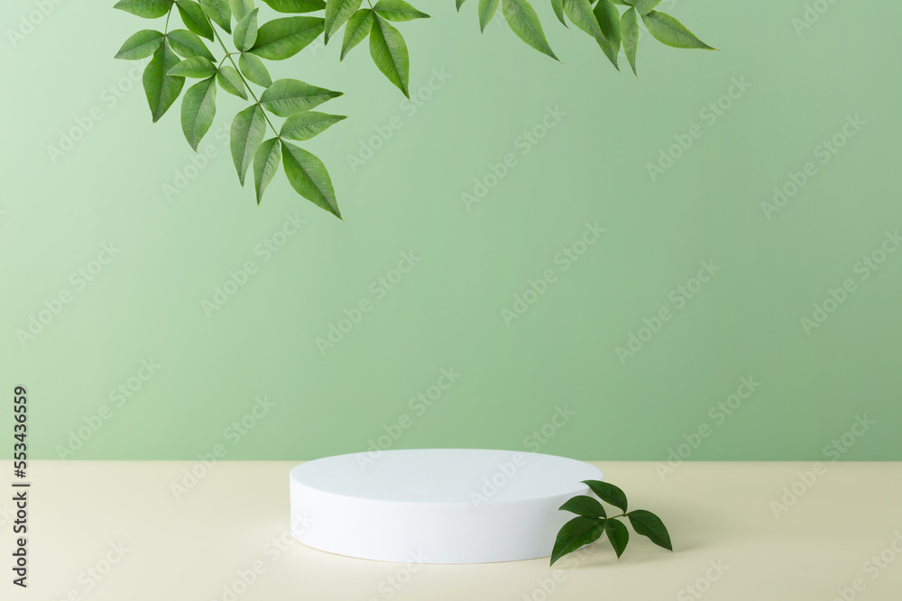 Abstract empty white podium with palm leaves on beige background Abstract empty white podium with palm leaves on beige background