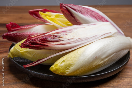 Fresh organic Belgian endivi or green and red chicory lettuce close up photo