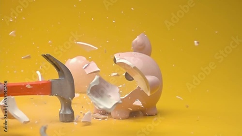 Breaking the piggy bank with hammer. Slow motion.
Piggy bank with money on orange background. photo