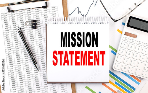 Mission Statement text on notebook with chart, calculator and pen