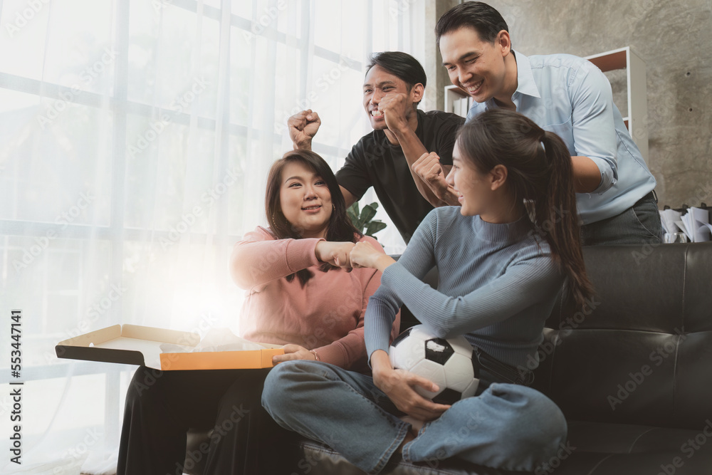 Excited friends having fun by watching football or soccer match and eating pizza at home. Friendship, leasure, rest, home party football, Soccer concept Excited friends having fun by watching football or soccer match and eating pizza at home. Friendship, leasure, rest, home party football, Soccer concept