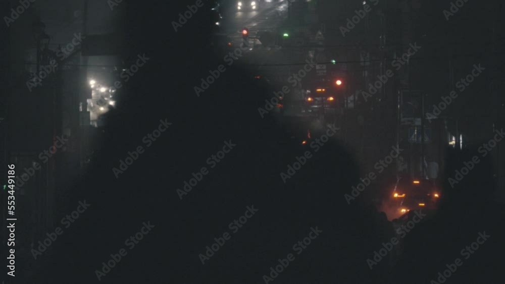 City traffic in the evening. Night city street with pedestrians and cars passing. Night city street with pedestrians and cars passing City traffic in the evening. Night city street with pedestrians and cars passing. Night city street with pedestrians and cars passing