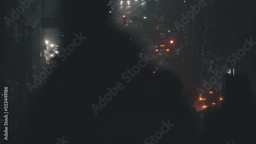 City traffic in the evening. Night city street with pedestrians and cars passing. Night city street with pedestrians and cars passing
