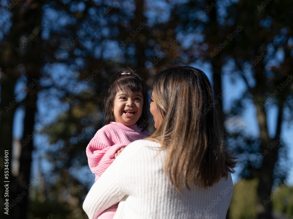 Obraz premium Mother hugging daughter with Down syndrome