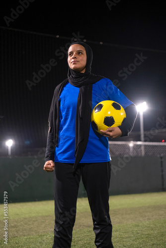 Portrait of female soccer player holding ball © Cultura Creative