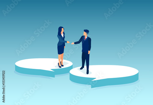 Vector of a man and a woman standing on a speech bubbles extending hands for a handshake