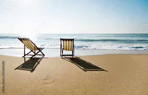 Fototapeta Naklejka Na Ścianę i Meble -  Two chairs on the beach.
