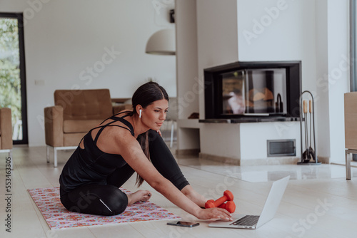 Young Beautiful Female Woman with Trainer via Video Call Conference in Bright Sunny House. Healthy Lifestyle, Wellbeing and Mindfulness Concept.