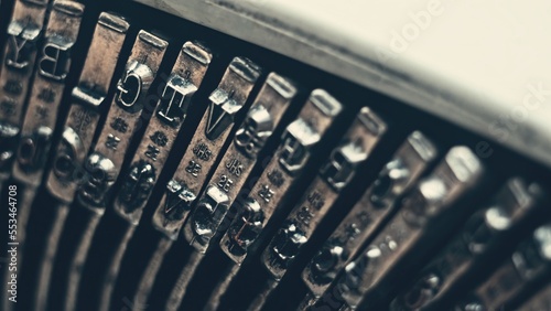Letters and numbers on typo keys of an old manual typewriter on a retro writing machine, close up view