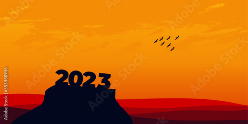 Happy New year 2023 with large silhouette letters on the mountain with a beautiful sunset for success concept. new year concept