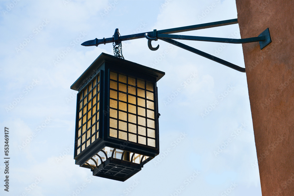 Beautiful vintage street lamp hanging on wall of building