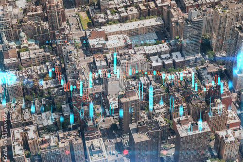 Aerial top view of New York City building roofs. Bird's eye view from helicopter of metropolis cityscape. Forex graph hologram. The concept of internet trading, brokerage and fundamental analysis