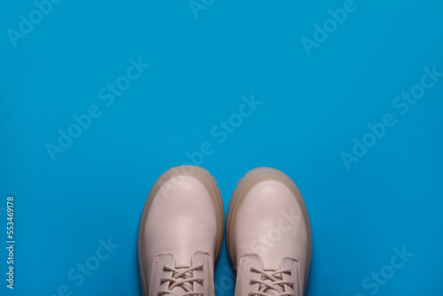Pair of stylish leather shoes on light blue background, flat lay. Space for text