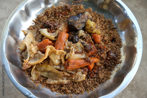 Thieboudienne or chebu jen: traditional national dish of Senegalese cuisine. Plate with thieboudienne with seafood in cafe in Senegal, Africa. African food, cuisine. Spicy Senegalese tiep or thieb photo