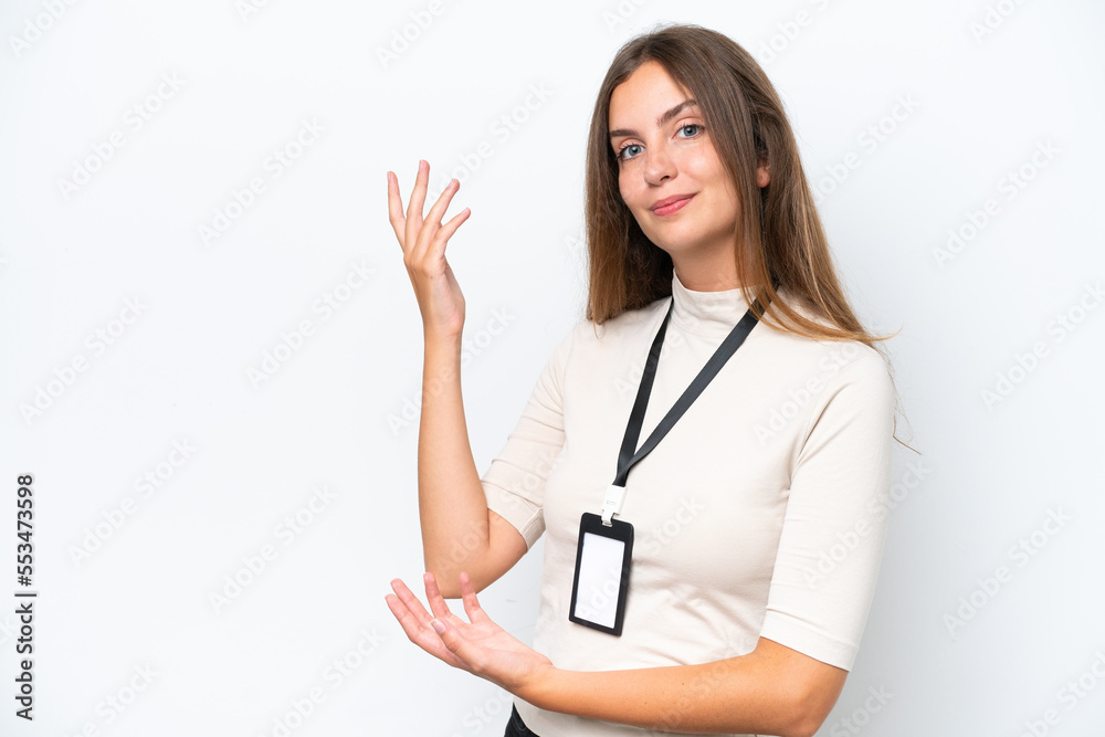 Young pretty woman with ID card isolated on white background extending hands to the side for inviting to come Young pretty woman with ID card isolated on white background extending hands to the side for inviting to come