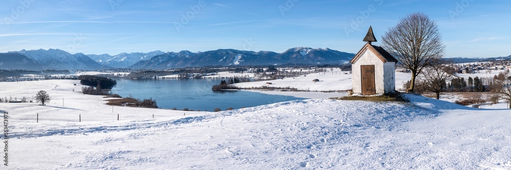 panoramic view to mountain range behind lake in winter