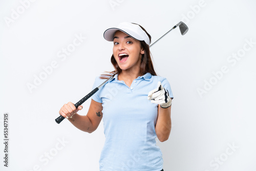 Young caucasian woman playing golf isolated on white background surprised and pointing front