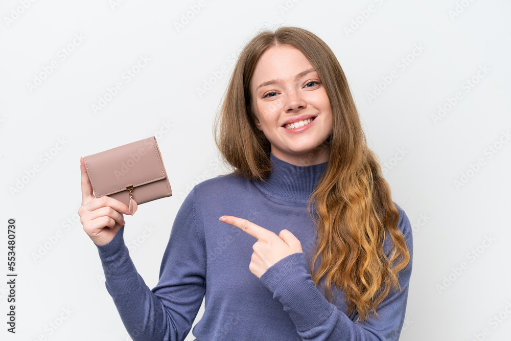 Young pretty woman holding wallet isolated on white background and pointing it Young pretty woman holding wallet isolated on white background and pointing it
