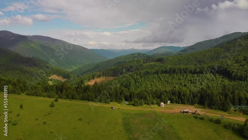 Aerial distance view on the top of the mountain pass, a man alone, are enjoying the nature. A tourist tent and a SUV vehicle with a roof rack. freedom and travel by car, Kolochava, Ukraine photo