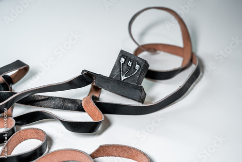 There is black leather tefillin on the table. Jewish traditions and religion (112) photo