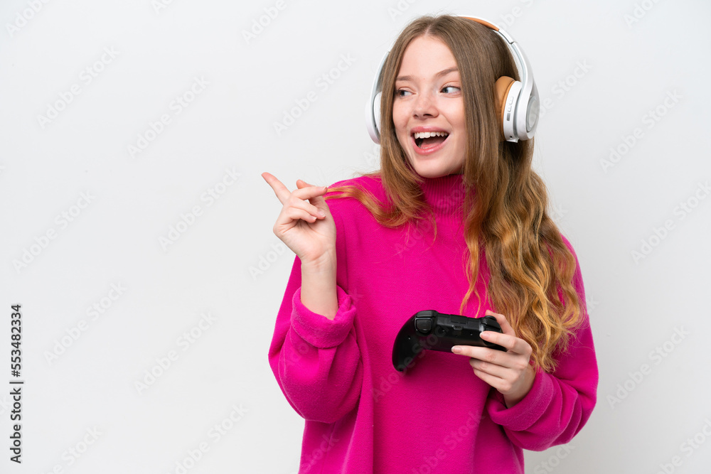 Young pretty woman playing with a video game controller isolated on white background intending to realizes the solution while lifting a finger up Young pretty woman playing with a video game controller isolated on white background intending to realizes the solution while lifting a finger up