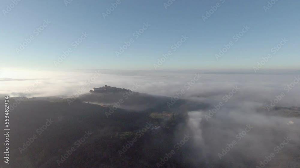 Tuscany hills sunset. Old castle on a mountain. Morning Fog Tuscany hills sunset. Old castle on a mountain. Morning Fog