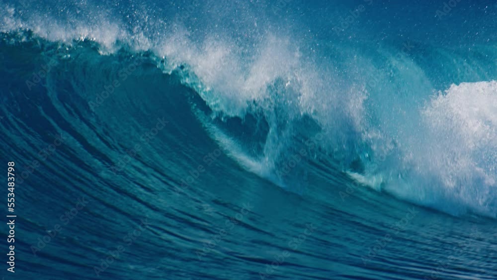 Powerful crystal clear ocean wave breaks on the shore in the Maldives Powerful crystal clear ocean wave breaks on the shore in the Maldives