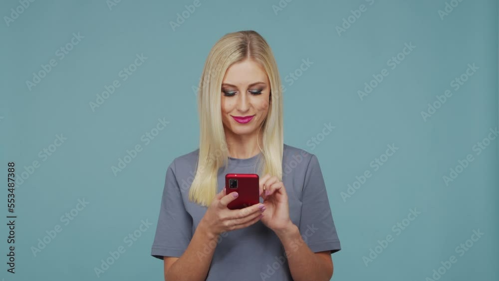Young beautiful blond girl in the studio. Portrait of emotional girl on blue background. Young beautiful blond girl in the studio. Portrait of emotional girl on blue background.