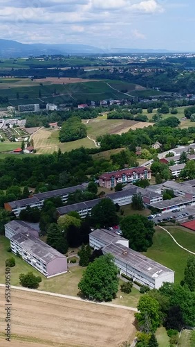 Vertical video of Aerial shot of village with low cost housings in Geneva countryside photo