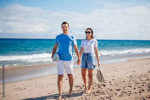 Young couple holding hands walking on the beach vacation