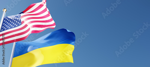 USA and Ukraine flags waving in the wind against a blue sky mockup with copy space. national symbols of the united states of america and ukraine 3d rendering