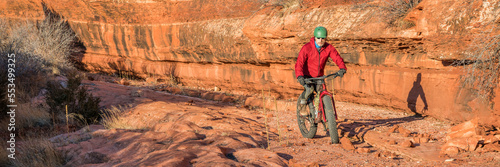 riding a fat mountain bike on a slickrock at the sandstone canyon bottom - Ruby Wash in Red Mountain Open Space north of Fort Collins, Colorado