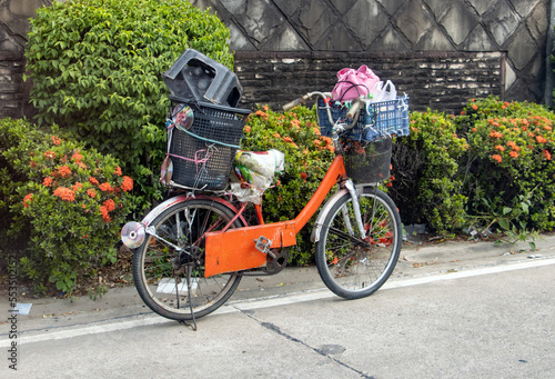 Photography A bicycle with a load is parked on the side of the road, Thailand