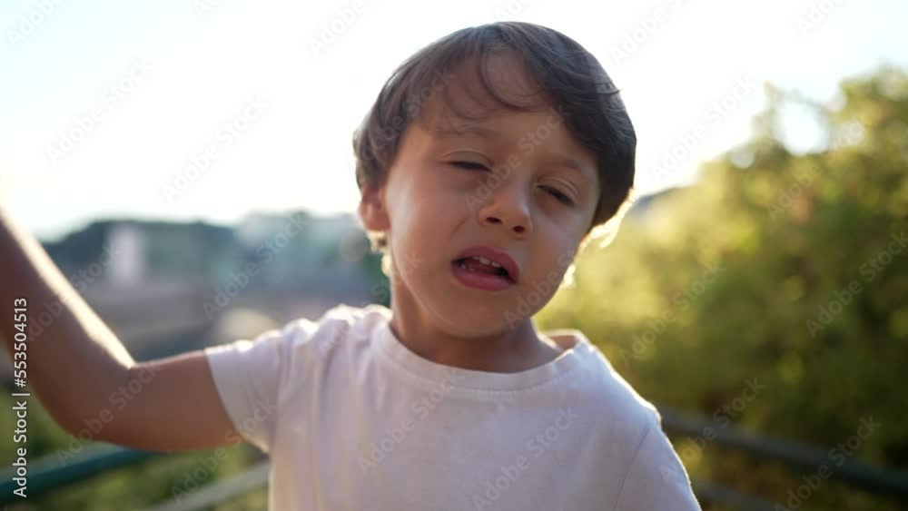 One little boy hitting own head with hand. Portrait of a child embarrassed by mistake standing outdoors. Oh no concept One little boy hitting own head with hand. Portrait of a child embarrassed by mistake standing outdoors. Oh no concept
