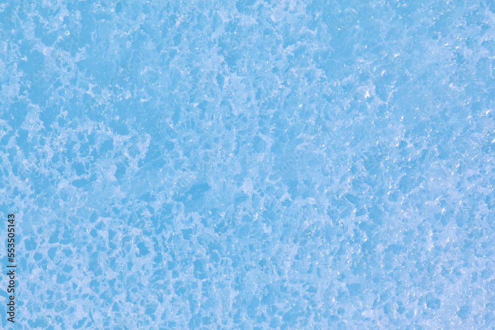 Texture of winter ice surface. Blue natural ice background