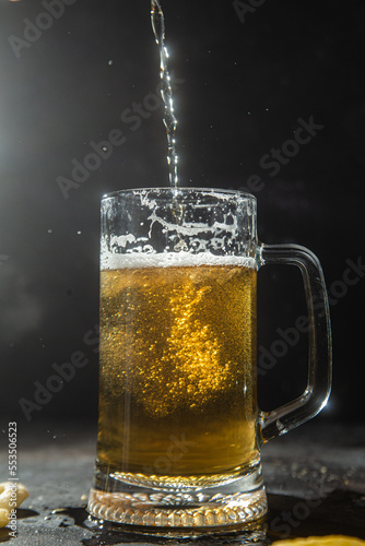 Light beer in a glass on a dark background