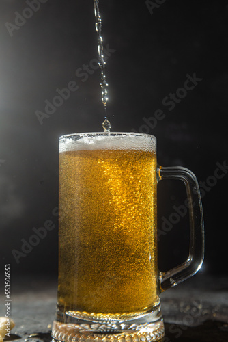 Light beer in a glass on a dark background