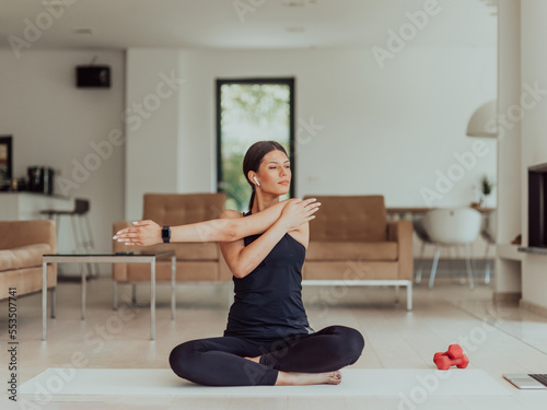 Fototapeta Naklejka Na Ścianę i Meble -  Young Beautiful Female Exercising, Stretching and Practising Yoga with Trainer via Video Call Conference in Bright Sunny House. Healthy Lifestyle, Wellbeing and Mindfulness Concept.