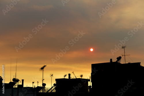 Buldings silhouettes in bright glowing gold sky background