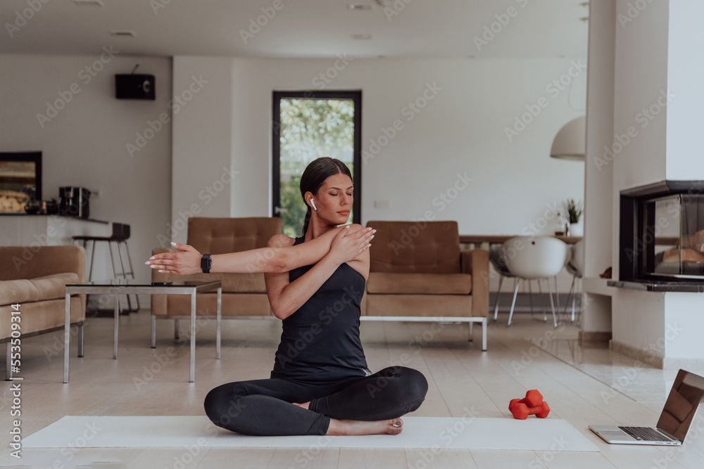 Young Beautiful Female Exercising, Stretching and Practising Yoga with Trainer via Video Call Conference in Bright Sunny Loft Apartment. Healthy Lifestyle, Wellbeing and Mindfulness Concept. Young Beautiful Female Exercising, Stretching and Practising Yoga with Trainer via Video Call Conference in Bright Sunny Loft Apartment. Healthy Lifestyle, Wellbeing and Mindfulness Concept.