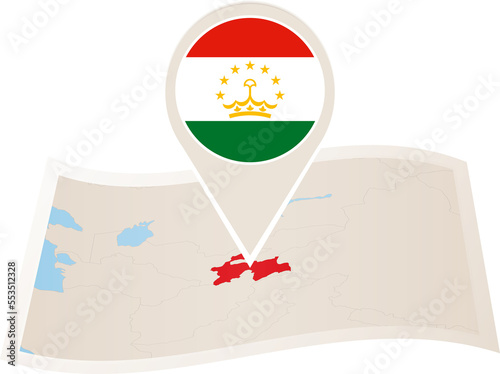 Folded paper map of Tajikistan with flag pin of Tajikistan.