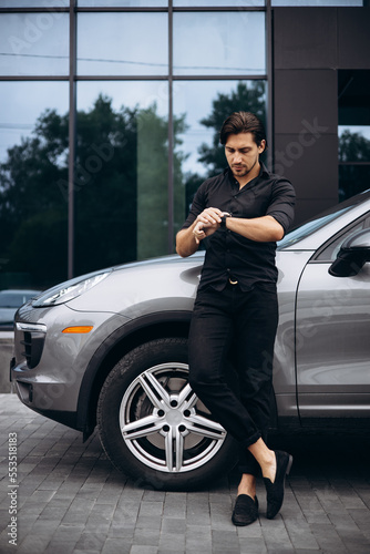 Handsome man standing by his new car © Petro