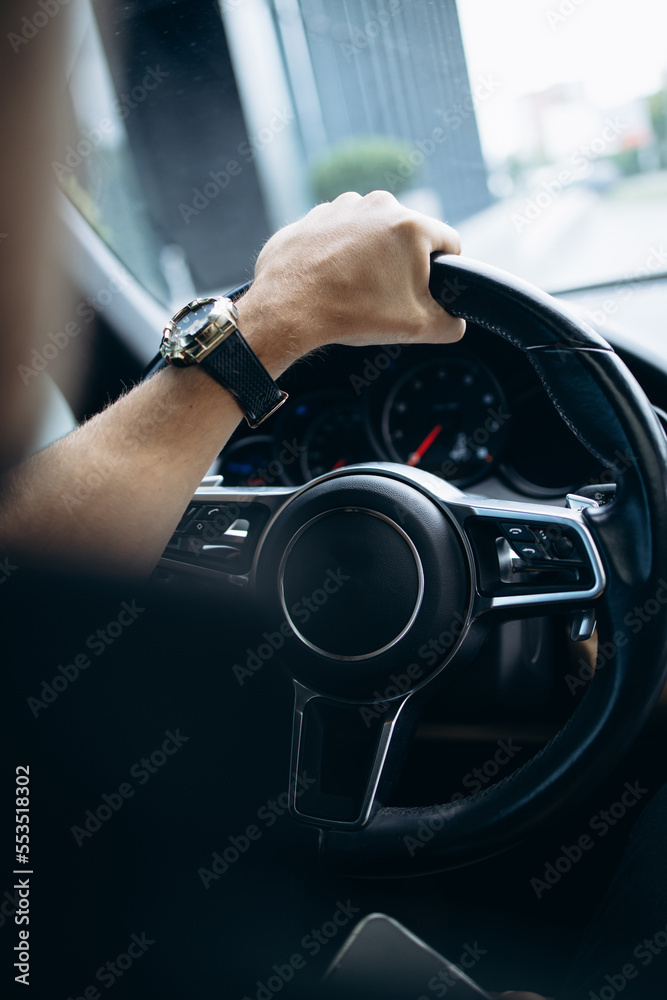 Man holding steering wheel close up photo