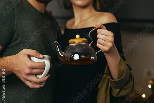 Man pouring tea during tea ceremony at home. Close up view. No face.