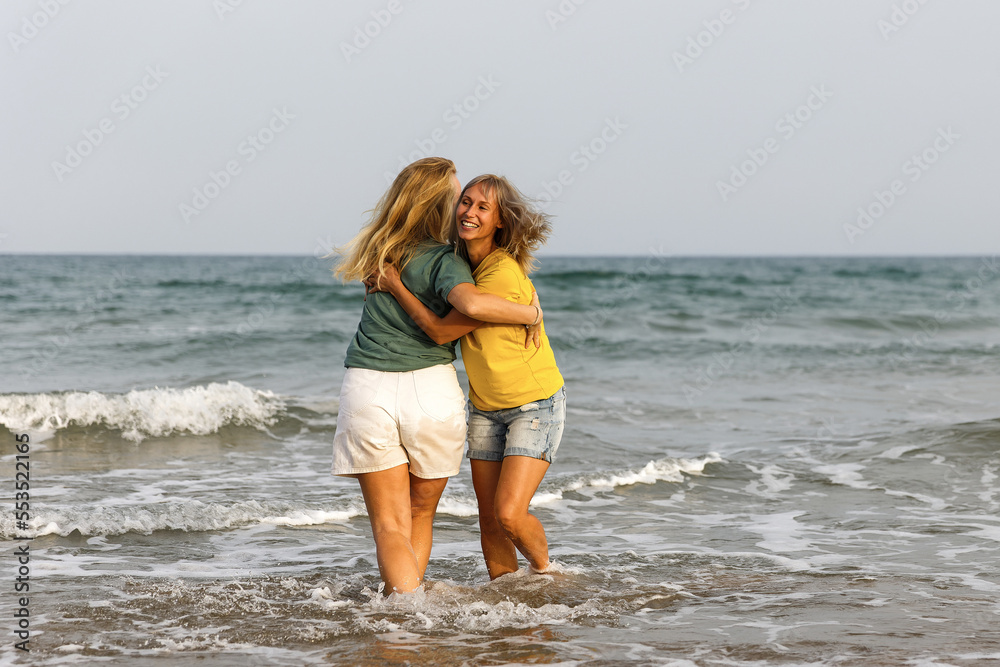 Girlfriends walk and have fun at the sea, family vacation at sea Girlfriends walk and have fun at the sea, family vacation at sea
