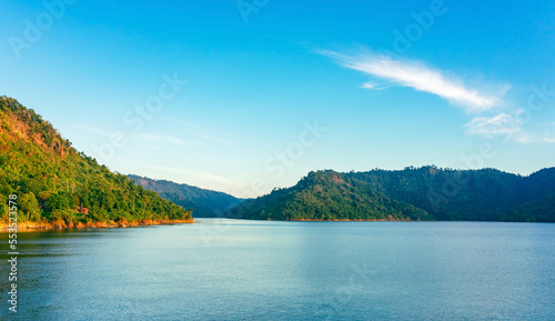 Beautiful and peaceful view of the river flowing through the mountains above the dam in the evening. River and mountain in Khun Dan Prakan Chon Dam in Thailand. ฺBeautiful Landscape. Tourism concept.