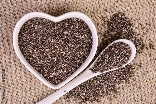 Chia seeds in a heart-shaped plate. Flat lay.
